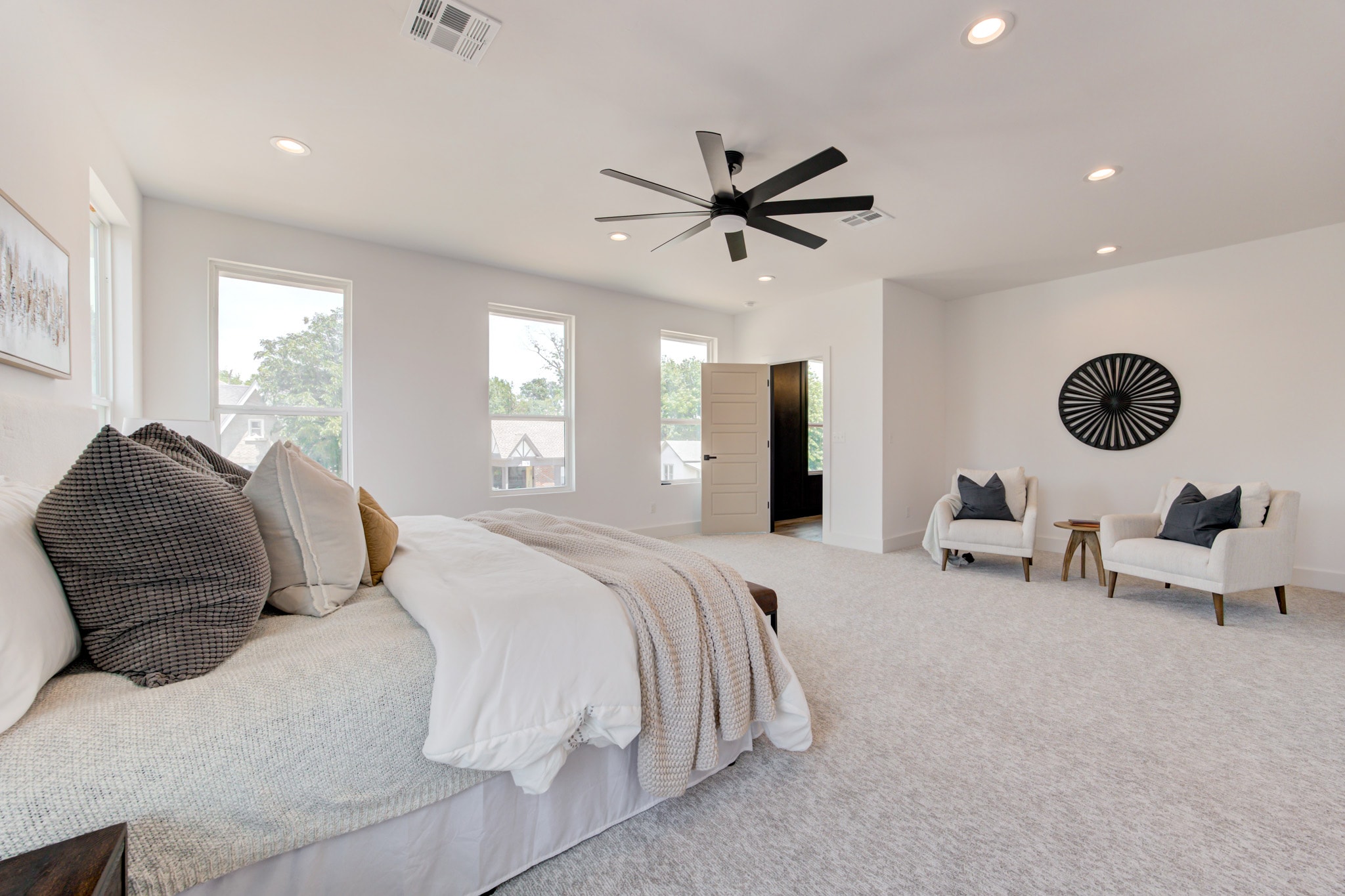 1014 NW 33rd St — primary bedroom with oversized layout and black ceiling fan