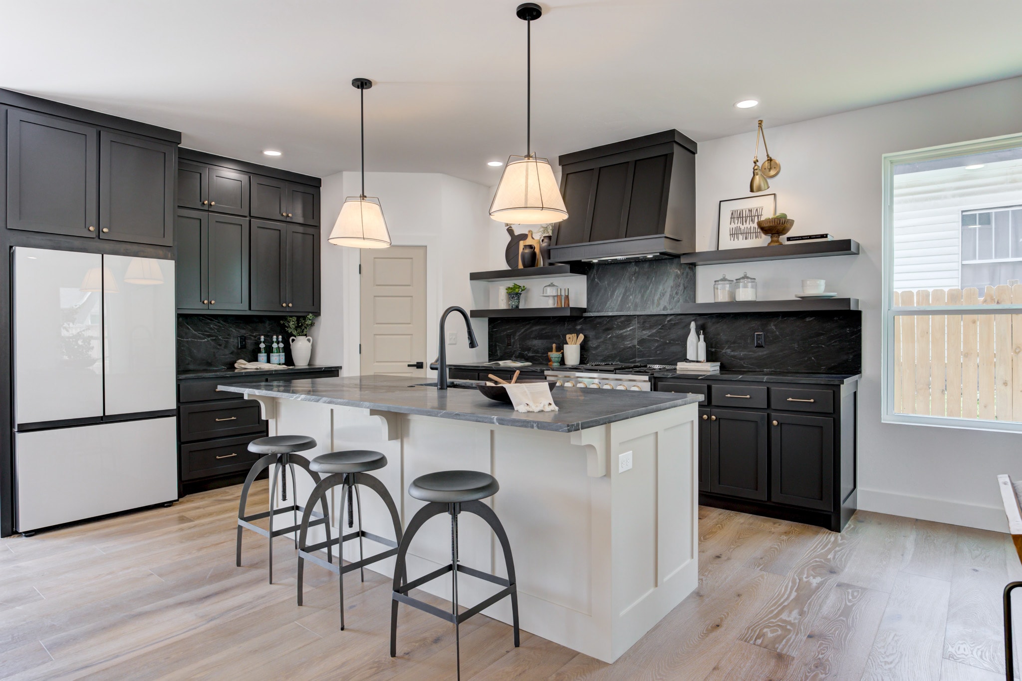 1014 NW 33rd St — black kitchen with white island and marble backsplash