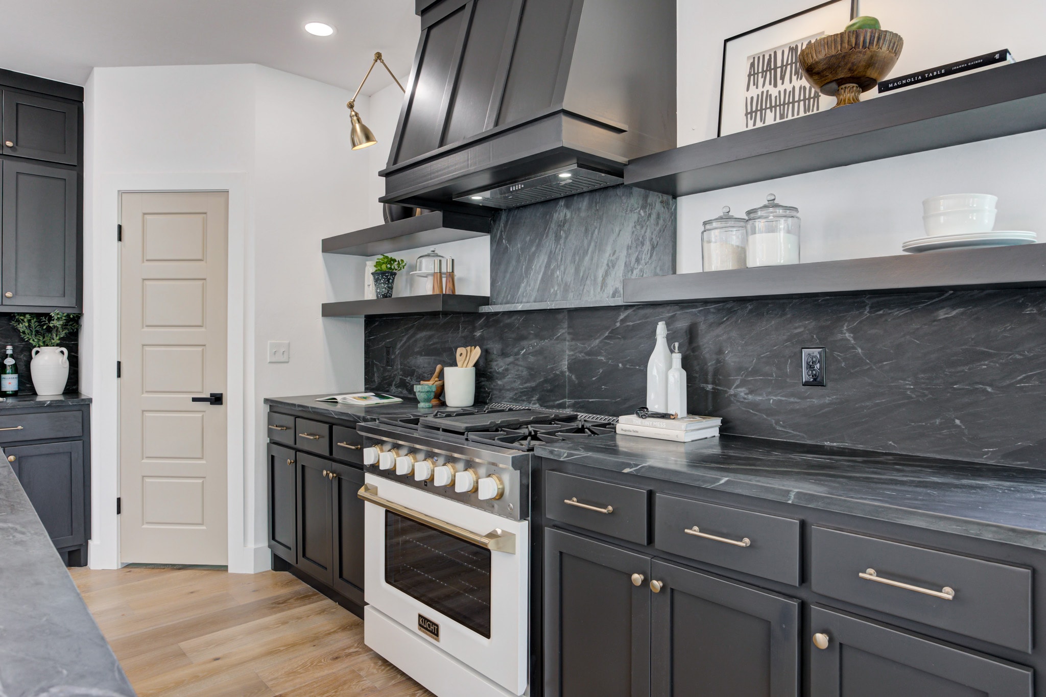 1014 NW 33rd St — Kucht range with black marble backsplash and open shelving