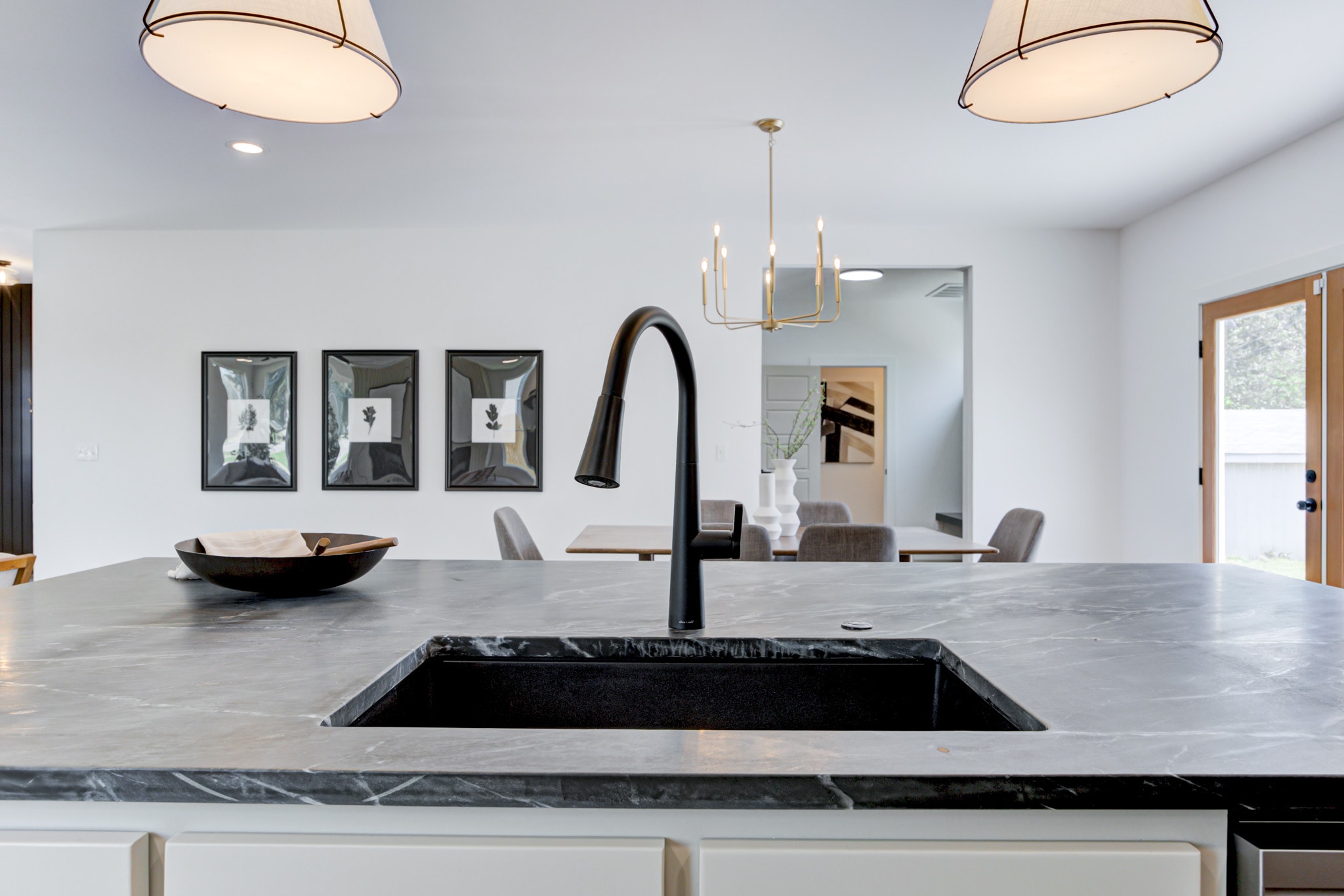 1014 NW 33rd St — island sink with black marble countertop and drum pendants