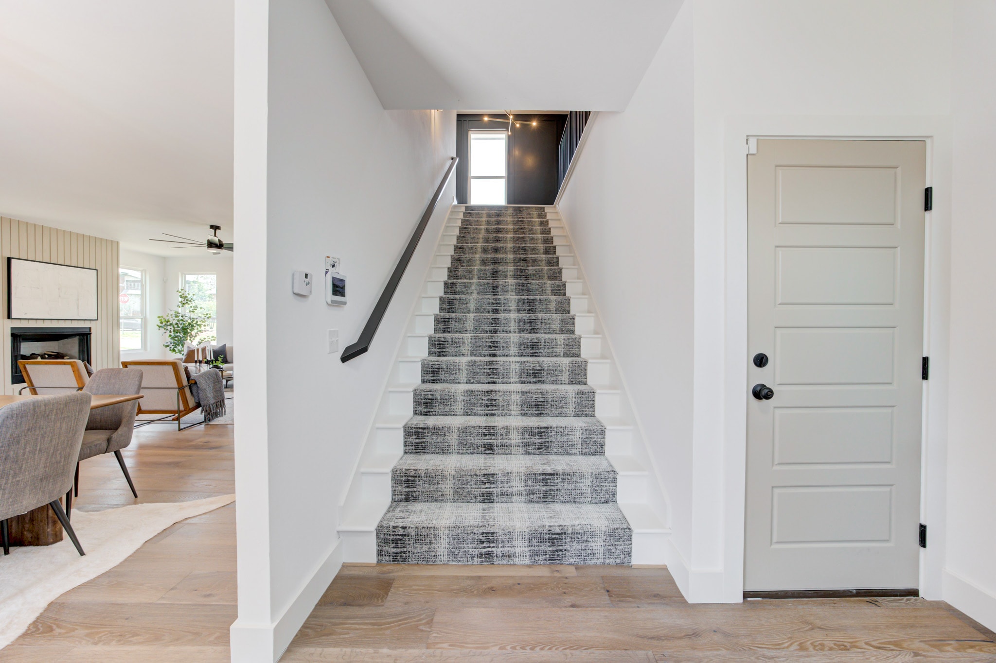 1014 NW 33rd St — staircase with patterned carpet runner and black railing