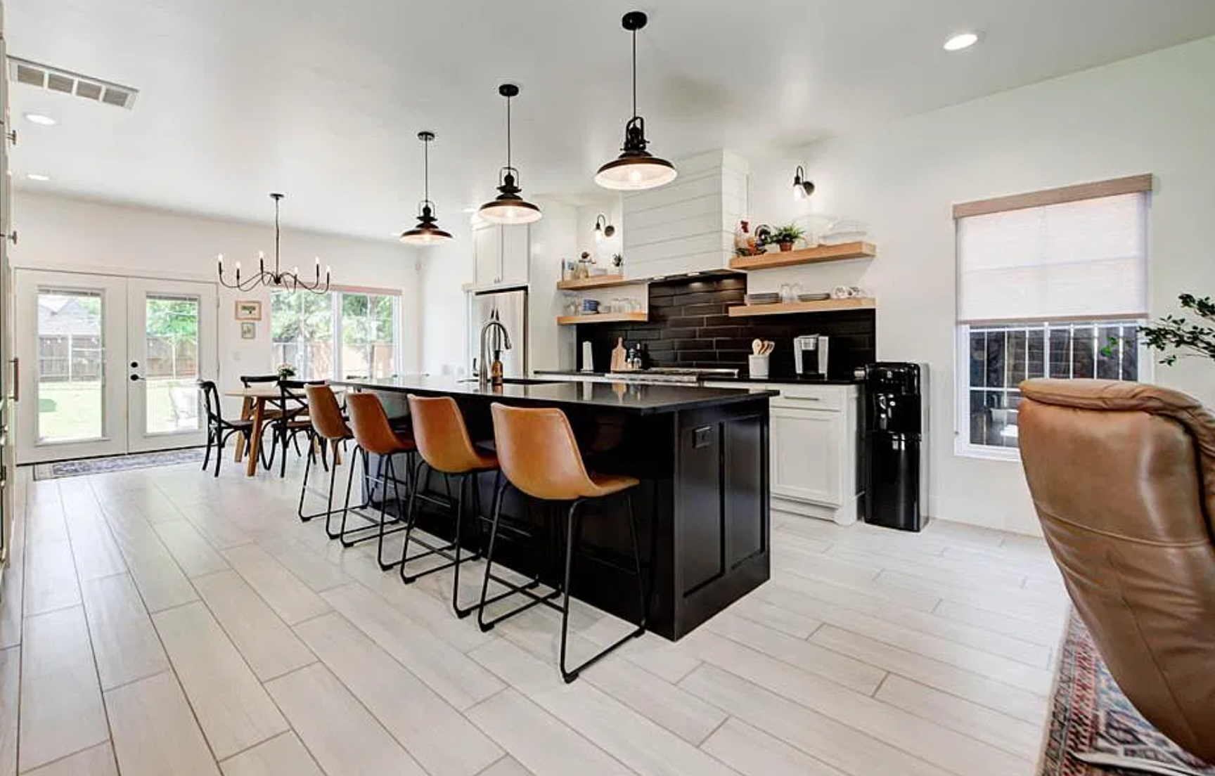 1124 NW 43rd St — foyer with black mudroom built-ins and herringbone stair runner
