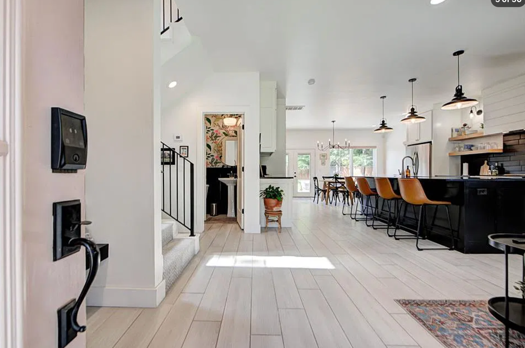 1124 NW 43rd St — open concept dining and living with iron chandelier