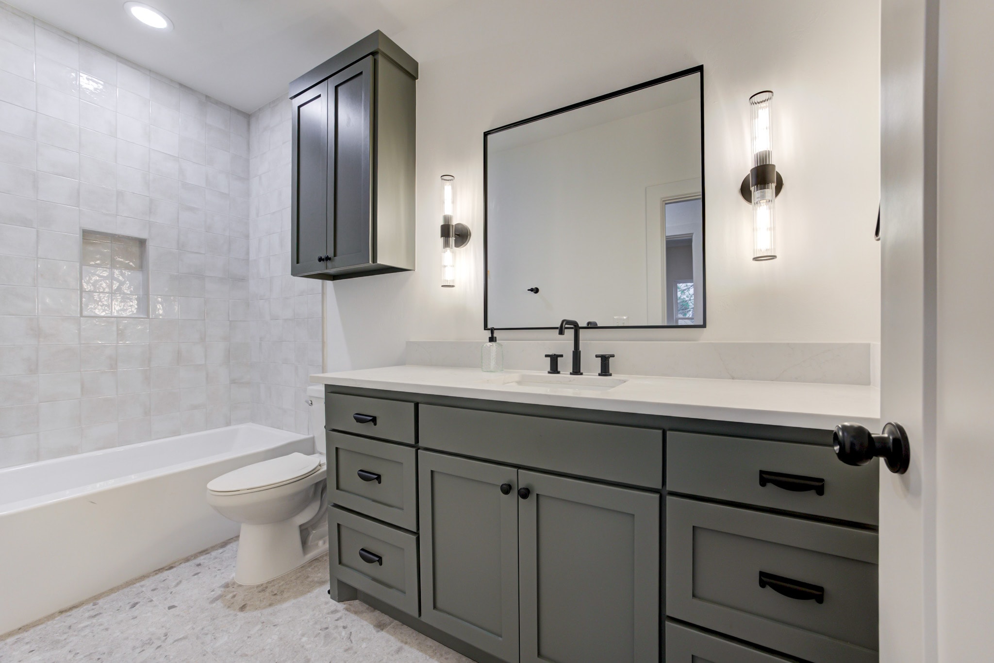1128 NW 49th St secondary bathroom with sage cabinetry